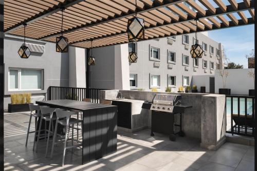 a patio with a grill and a table and chairs at Homewood Suites By Hilton Saltillo in Saltillo