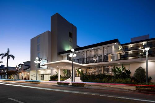 a building at night with a street in front of it at The Harrison Hotel Downtown Hollywood FL, an Ascend Collection Hotel in Hollywood