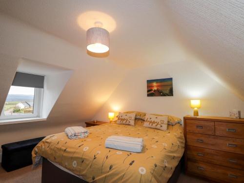 a bedroom with a bed and a dresser and a window at Nanville in Beauly