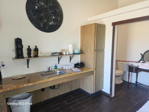 a bathroom with a sink and a toilet at Sunrise Springs in Pahrump