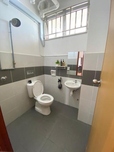 a bathroom with a toilet and a sink at Anggerik Camelia Homestay Apartment Ladang Tok Pelam FREE WIFI in Kuala Terengganu