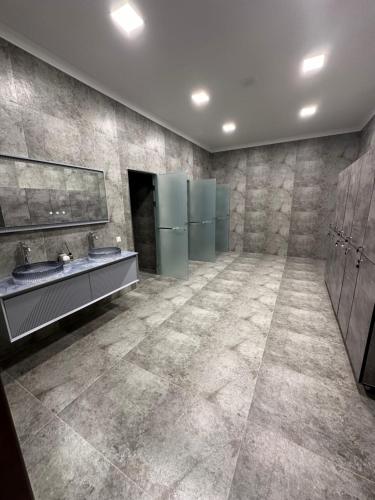 a bathroom with two sinks and two mirrors at Ark hotel PREMIUM in Bukhara