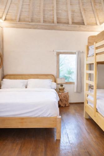 a bedroom with two bunk beds and a window at Greengo Private POOL VILLA in Gili Meno