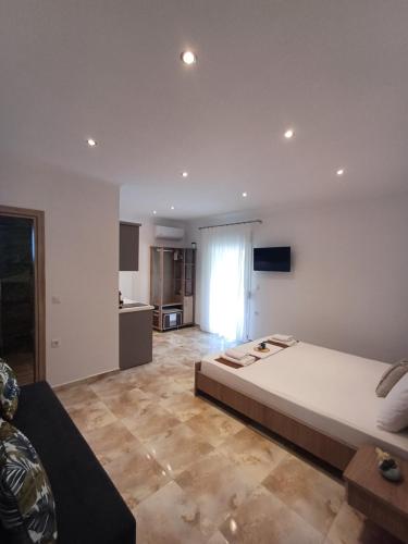 a large bedroom with a large bed and a kitchen at Summer Paradise in Paralia Sikias