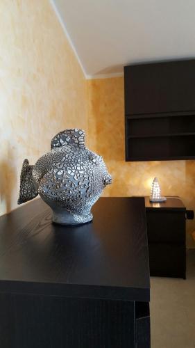 a glass fish vase sitting on a black table at La Casa di Ninna Affittacamere in Ariano Irpino