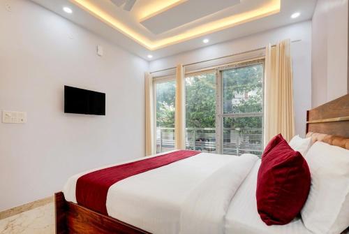 a bedroom with a large bed and a window at Super Hotel Pari Chowk Formerly The Divine KRC in Greater Noida