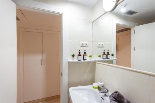 a bathroom with a sink and a mirror at nice seafront apartment in Almuñécar