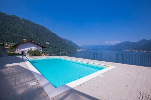 a swimming pool with a view of the water at Residence degli Oleandri 6A in Argegno