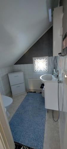 an attic bathroom with a sink and a toilet at Omakotitalo Pirintie 22, Härmä in Kauhava
