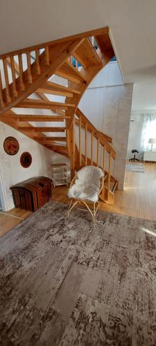 a living room with a chair sitting on the floor at Omakotitalo Pirintie 22, Härmä in Kauhava