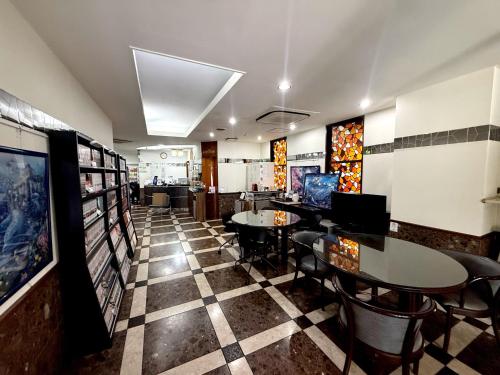 a restaurant with tables and chairs on a checkered floor at アーバンホテル森下 in Tokyo