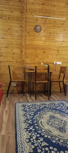 a room with a table and two chairs and a table and bench at wood house vattakanal in Kodaikānāl