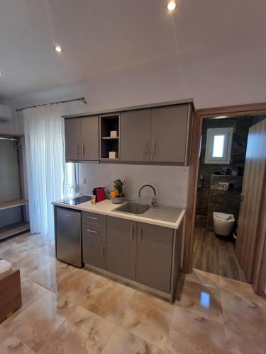a kitchen with a sink and a counter top at Summer Paradise in Paralia Sikias
