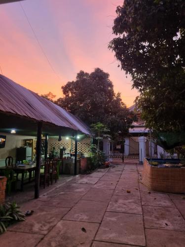 an outdoor patio with a sunset in the background at Our Place Silk Island in Silk Island