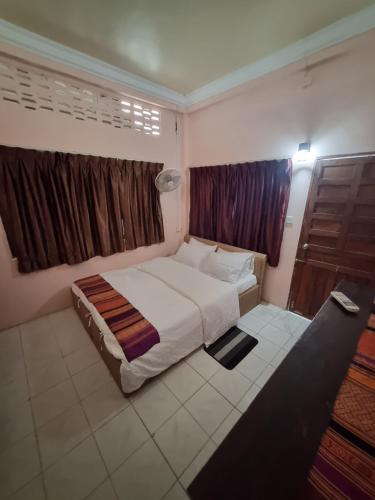 a bedroom with a large bed and a window at Our Place Silk Island in Silk Island