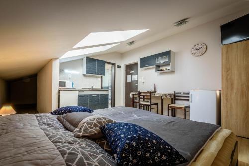 a bedroom with a large bed with pillows on it at Central House in Štúrovo