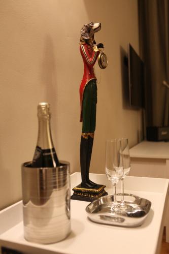 a statue of a woman playing a trumpet next to a wine glass at ZevenVrijeDagen in Ghent