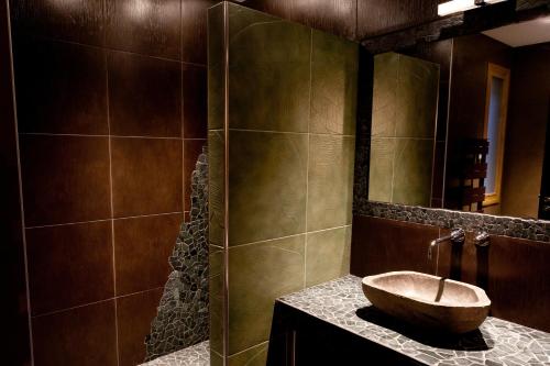 a bathroom with a bowl sink on a counter at Château de la Falque, The Originals Relais in Saint-Geniez-dʼOlt