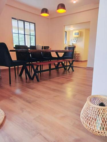 a dining room with a large table and chairs at Clover Cottage in Nuwara Eliya