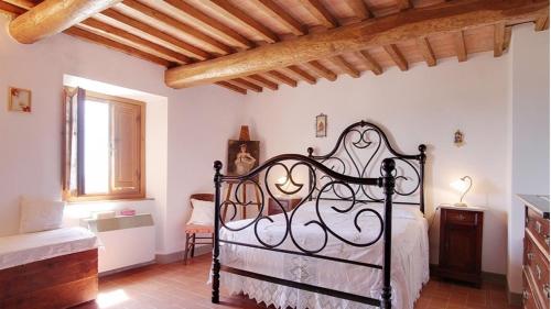 a bedroom with a black bed in a room at Villa Rachele in Larciano