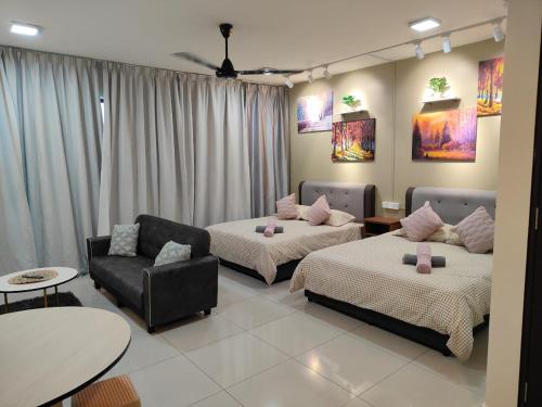 a living room with two beds and a couch at Trefoil Studio Unit Near Setia City Mall 1-5 Pax in Shah Alam