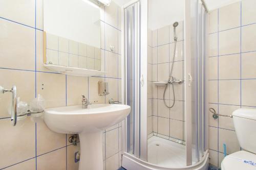 a bathroom with a sink and a shower and a toilet at Motel Blue River Calimanesti in Călimăneşti