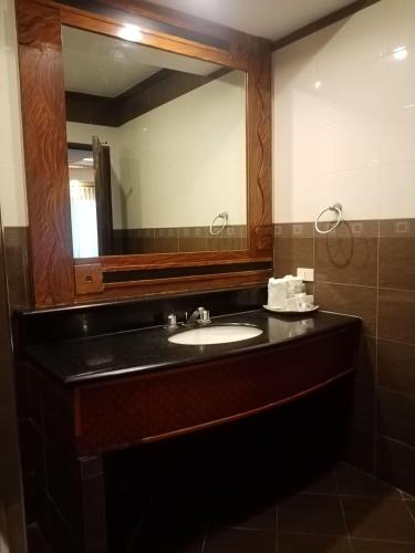 a bathroom with a sink and a mirror at MO2 Westown Hotel - Mandalagan in Bacolod