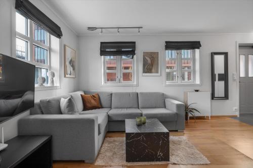a living room with a couch and a table at Northstay - Skansegata Apartments, Apartment B l One-Bedroom in Tromsø