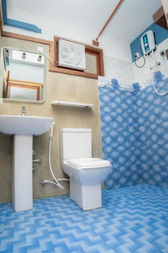 a bathroom with a toilet and a sink and a shower at Heaven Upon Rice Fields in Anuradhapura