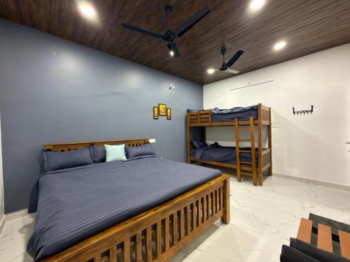 a bedroom with a bed and a bunk bed at Yelagiri castle in Yelagiri