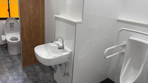 a bathroom with a sink and a toilet at 楽校うらしり in Uwajima