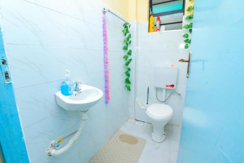 a bathroom with a sink and a toilet at A&M Luxury bnbs in Nairobi