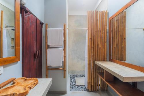 a bathroom with a sink and a shower at Gemello Bali Villa in Keramas