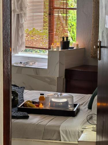 a tray of food sitting on top of a bed at Ui Views in Margate