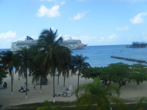 a beach with two cruise ships in the water at Dunn's Apartments at Sandcastles in Ocho Rios