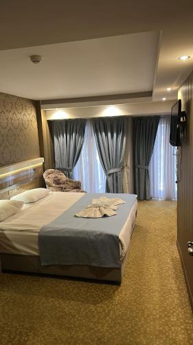 a hotel room with a large bed with curtains at Rain Golden Hotel in Istanbul