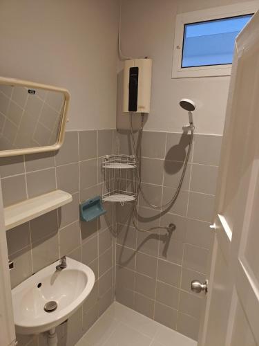 a bathroom with a shower and a sink at QG restaurant and guesthouse in Hua Hin