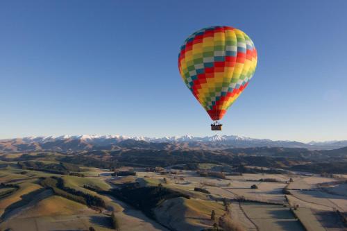 a colorful hot air balloon flying in the sky at Taylors Motel in Ashburton