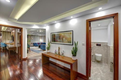 a living room with white walls and wooden floors at Pearl Continental Hotel, Bhurban in Bhurban