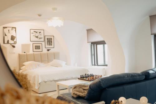 a living room with a bed and a couch at Brána historic Boutique Apartments in Horažďovice