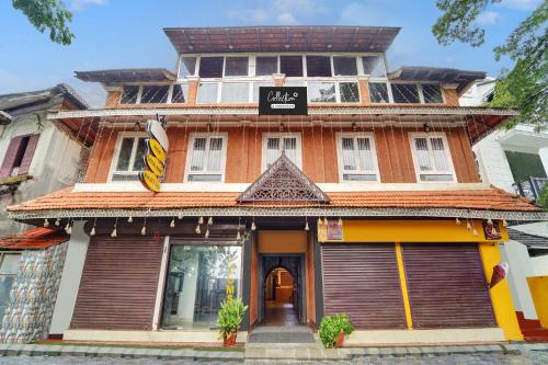 a building with a sign on the front of it at Collection O Calvathy Road Near Fort Kochi in Cochin