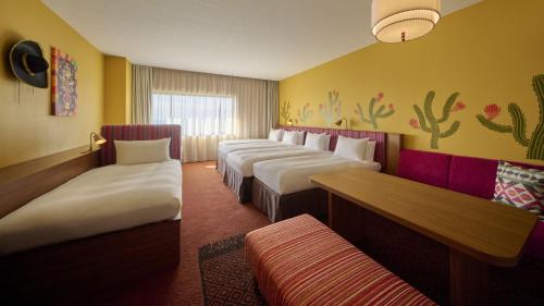 a row of beds in a hotel room at The Royal Park Hotel Maihama Resort Tokyo Bay in Urayasu