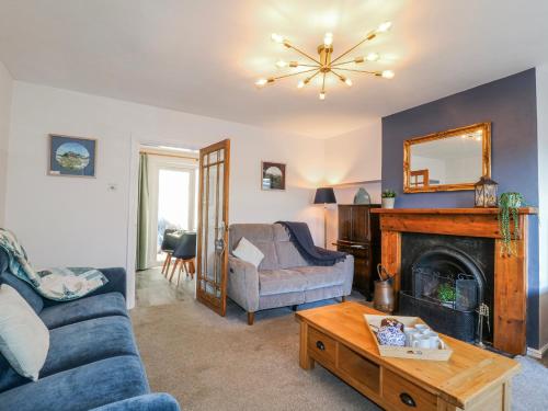 a living room with a couch and a fireplace at Scamnel in Stafford