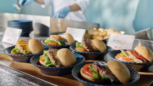 a bunch of sandwiches in bowls on a buffet at The Royal Park Hotel Maihama Resort Tokyo Bay in Urayasu