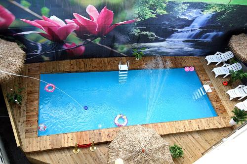 an overhead view of a swimming pool with pink flowers at Gangchon Beautiful Pension in Chuncheon