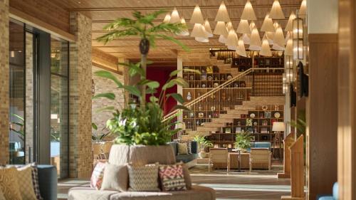 a living room with a couch and a staircase at The Royal Park Hotel Maihama Resort Tokyo Bay in Urayasu
