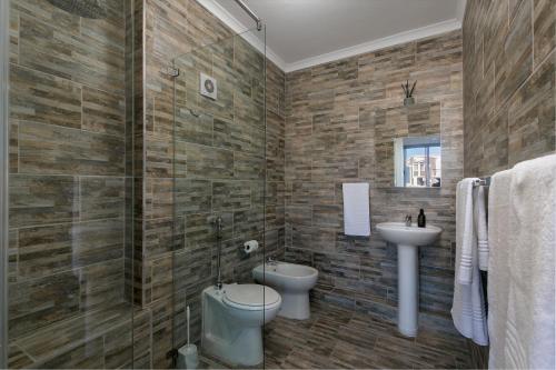 a bathroom with a toilet and a sink at Knysna Waterfront, Stunning Views in Knysna