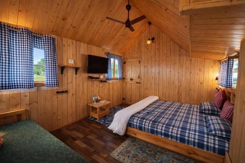 a bedroom with a bed in a wooden cabin at Sierra Vista Resort in Nashik