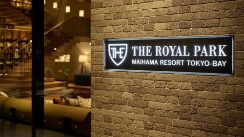a sign for the royal park millennium resort tko bay on a brick wall at The Royal Park Hotel Maihama Resort Tokyo Bay in Urayasu