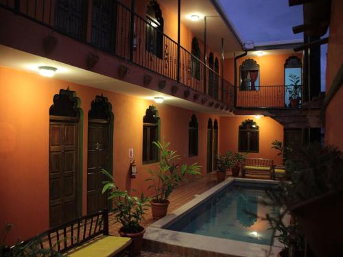 a house with a swimming pool at night at Boutique Hotel Maharaja in Granada